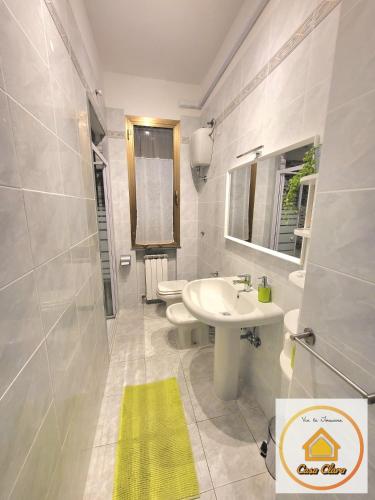 a bathroom with a sink and a toilet and a mirror at Casa Clara in Cerreto Guidi
