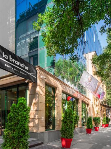 a store front with plants inront of a building at Crystal Palace Boutique Hotel in Sofia