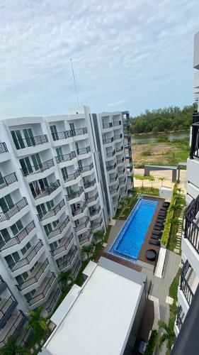 an aerial view of apartment buildings with a swimming pool at BEACH Condo Mae Phim in Ban Tha Fat