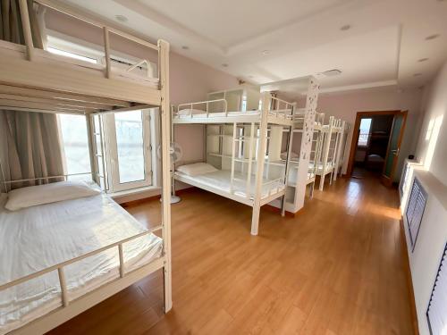 a room with three bunk beds in a room at Burj24 Rooftop Hostel in Ulaanbaatar