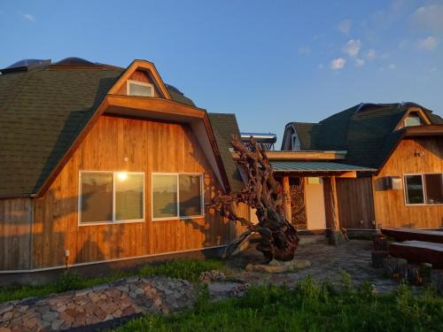 a wooden house with a roof at Twin Dome Ryugu in Hokuto