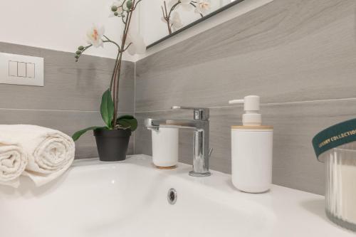 a bathroom with a sink with two bottles on it at Magic Rent - Appartamento Gluck in Milan