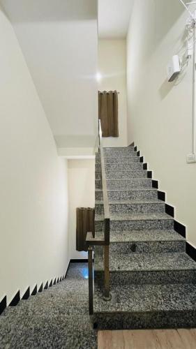 a staircase in a building with a stair case at ECR Happy Nest villa in Mahabalipuram