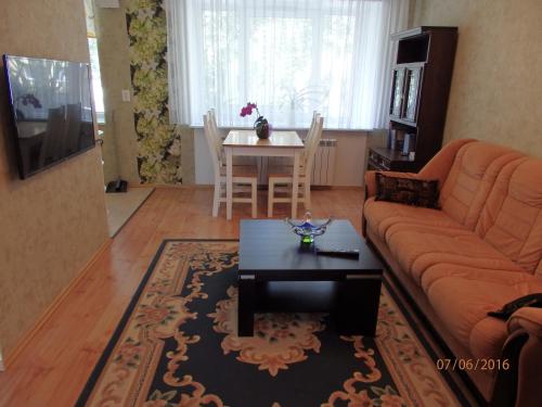 a living room with a couch and a table at Torni Apartment in Kuressaare