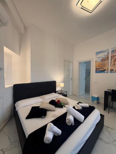 a bedroom with a large bed with towels on it at Re di Roma Rooftop in Rome