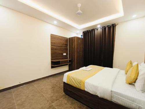 a hotel room with a bed and a cabinet at The Royal casa in Ghaziabad
