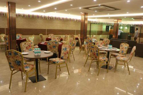 a restaurant with tables and chairs in a room at The Royal casa in Ghaziabad