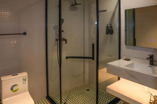 a bathroom with a shower and a toilet and a sink at Viriya Hotel in Luang Prabang