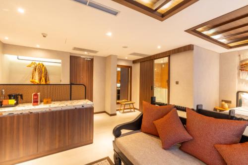 a living room with a couch and a counter at Episode Kuta Bali in Kuta