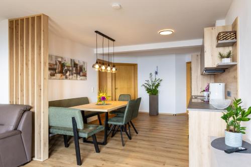 a dining room and living room with a table and chairs at Haus Silvia in Werfenweng