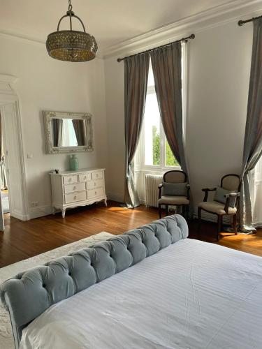 a bedroom with a bed and a dresser and a mirror at Chateau de Minargent in Aulnay
