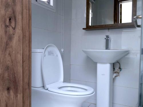 a bathroom with a white toilet and a sink at Luxury House - Sleeps 8 & Free Parking in Abuja