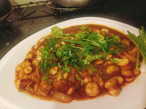 a plate of food with beans and greens on it at BMB Boun Marvin Payham Bungalows in Ko Phayam