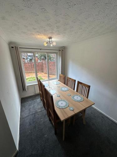a dining room with a long table and chairs at Tartan Nest- Entire house- Sleeps 8 guests in Mansewood