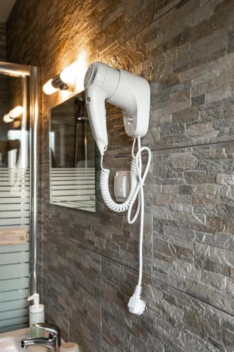 a hairdryer on the wall of a bathroom at Haus Kärnten in Döbriach