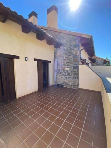 a house with a tiled patio in front of it at Coqueto apartamento dúplex - Portal de Ordesa in Fiscal