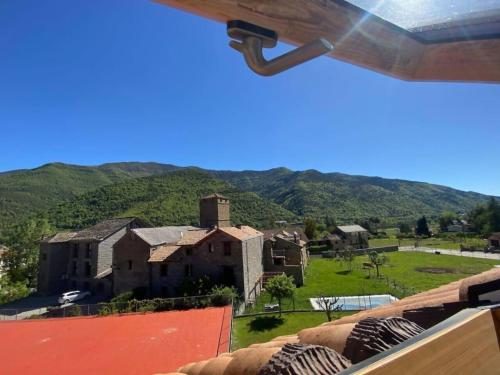 a view of a house with mountains in the background at Coqueto apartamento dúplex - Portal de Ordesa in Fiscal