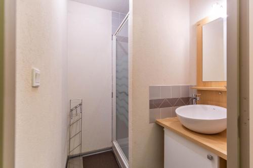 a bathroom with a sink and a glass shower at Le Balcon de Barèges - Vue Montagne in Barèges