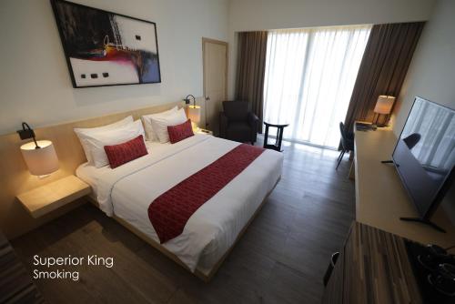 Una cama o camas en una habitación de Grand Zuri BSD City