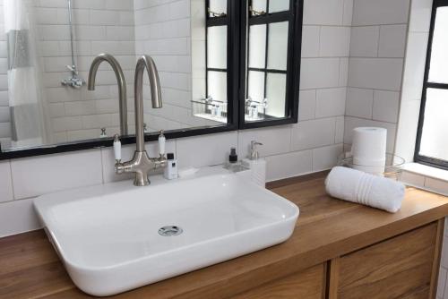 a bathroom with a sink and a mirror at Villa Viva Cape Town in Cape Town
