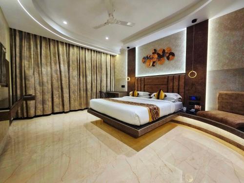 a bedroom with a king sized bed and a couch at Malligi,Hampi in Hospet
