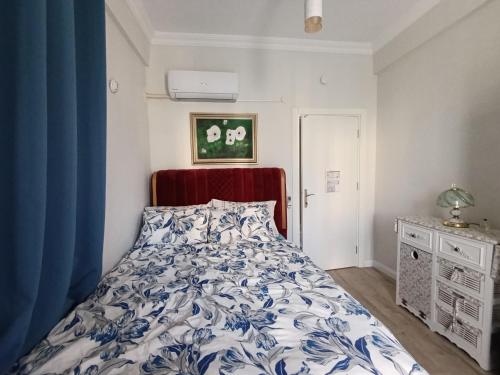 a bedroom with a bed with a blue and white comforter at side side in Side