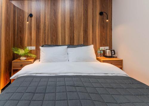 a bedroom with a large bed with wooden walls at Piola Hotel Kadıköy in Istanbul