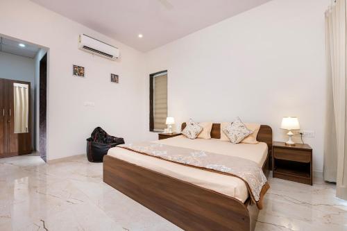 a bedroom with a large bed in a room at Urban Hideout - a mini farmhouse in Jaipur