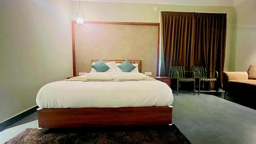 a bedroom with a large bed and a living room at The village vista in Batheri