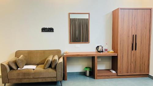 a living room with a couch and a table at The village vista in Batheri