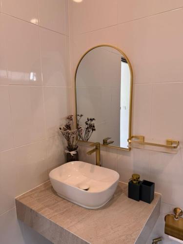 a bathroom with a white sink and a mirror at House with pool Srithanu Beach 2 in Koh Phangan