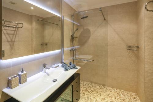 a bathroom with a sink and a shower at Casa Carvoeiro Bay J in Carvoeiro