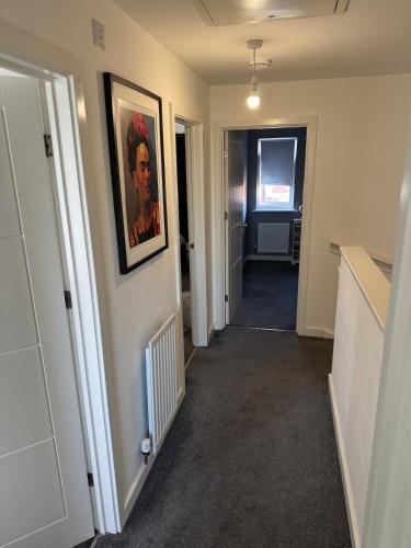 a hallway with a painting hanging on a wall at 14 Lumb close in Swindon
