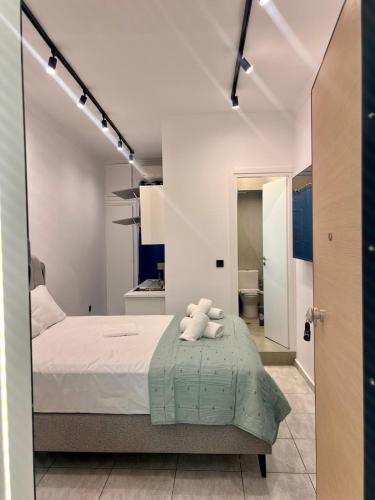 a bedroom with a bed with a teddy bear on it at Family Luxury Suite by Zeus Suites in Athens