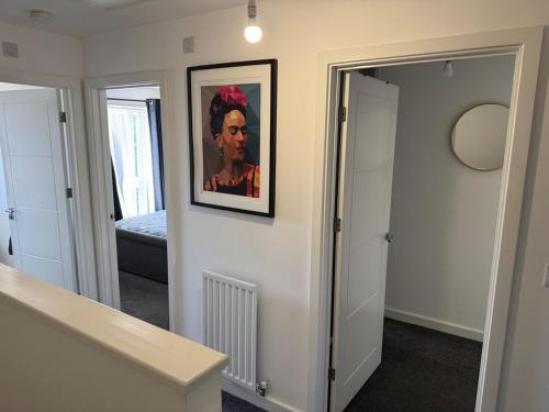 a hallway with a painting of a man on a wall at 14 Lumb close in Swindon
