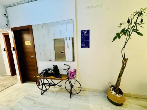 a room with a table and a plant and a mirror at Family Luxury Suite by Zeus Suites in Athens