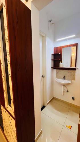 a bathroom with a sink and a mirror at Aesthetic Studio near Chettinadu Hospital in Kelambākkam
