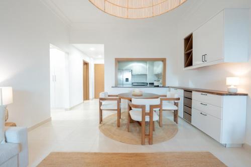 a kitchen and dining room with a table and chairs at 2 bedroom Tranquil Retreat in Ansam in Abu Dhabi