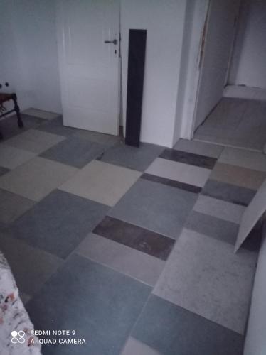 a room with a checkered floor and a door at Summer house in Belgrade in Slanci