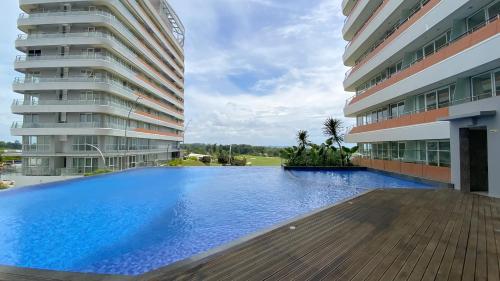 a large swimming pool in front of a building at REOTEL at THE NOVE - NUVASA BAY serviced Apartment in Pulau Nongsa