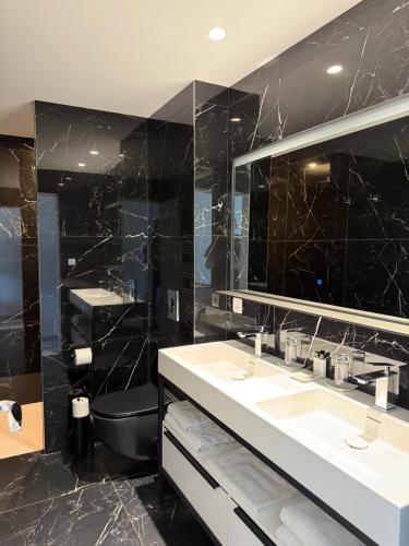 a bathroom with two sinks and a mirror at VILLA MIAMI in Les Issambres