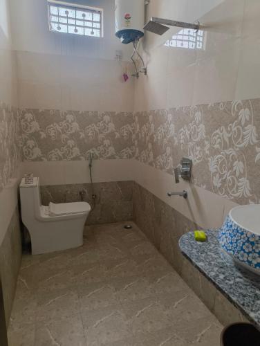 a bathroom with a toilet and a sink at Rising Shemesh Home Stay in Udaipur