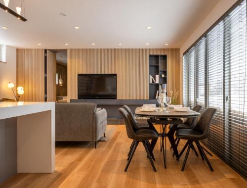 a living room with a table and chairs and a couch at Forest Avenue 64 in Niseko