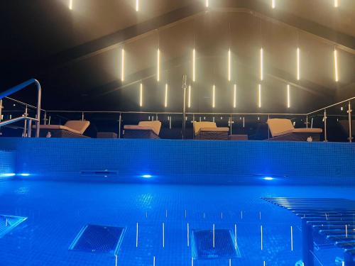 a swimming pool at night with chairs and lights at Park hall Hotel & Spa Lancashire, a member of Radisson Individuals in Eccleston