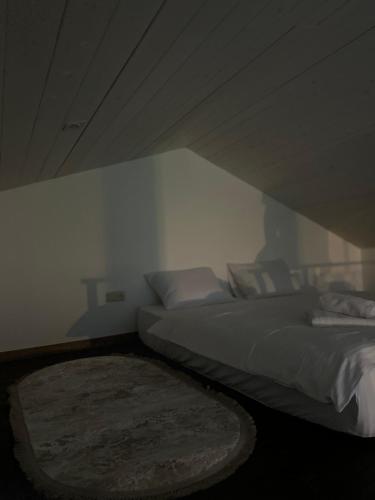 a bedroom with two beds and a rug at Field house in Slavske