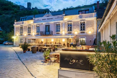 a large building with tables and chairs in front of it at Gasthof Prankl in Spitz