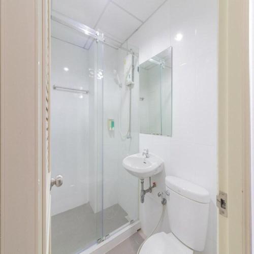 a bathroom with a shower and a toilet and a sink at Collection O Siam Privi Hotel in Bangkok