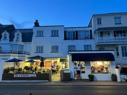 a building with a restaurant in front of it at De L'Etang in Saint Helier Jersey