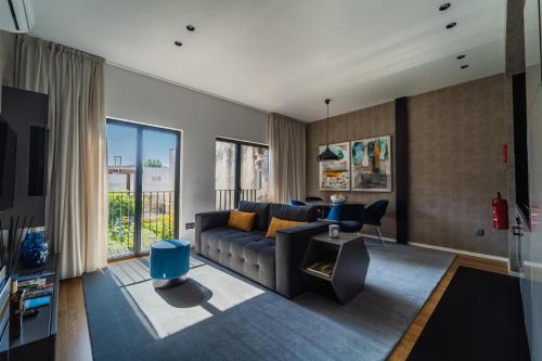 a living room with a couch and a table at Lux Housing Século XXI in Braga