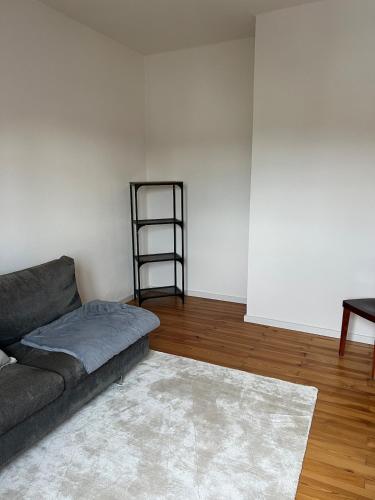 a living room with a couch and a shelf at Elegantes Apartment in Villa in Ottobeuren
